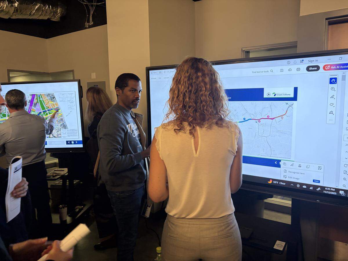 Sean Langley, president of the McCrorey Heights neighborhood association, speaks to a representative from the North Carolina Department of Transportation on I-77 South Express Lanes project at Johnson C. Smith University.