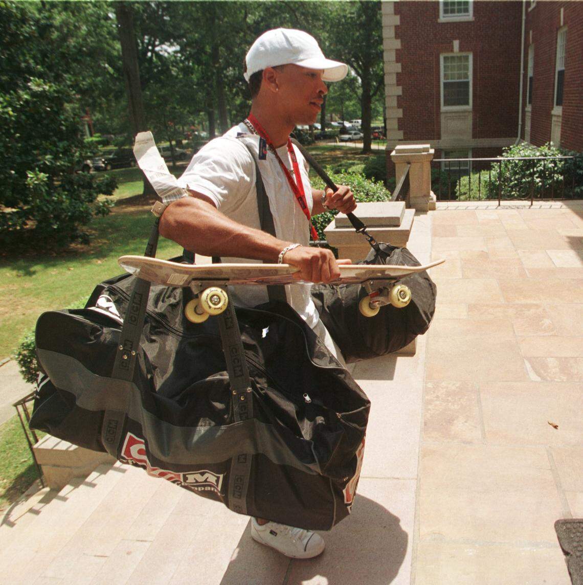 7/28/99 Panther Rae Carruth has his hands full as he enters Greene Hall on the campus of Wofford College and he and other veterans reported to training camp Thursday.