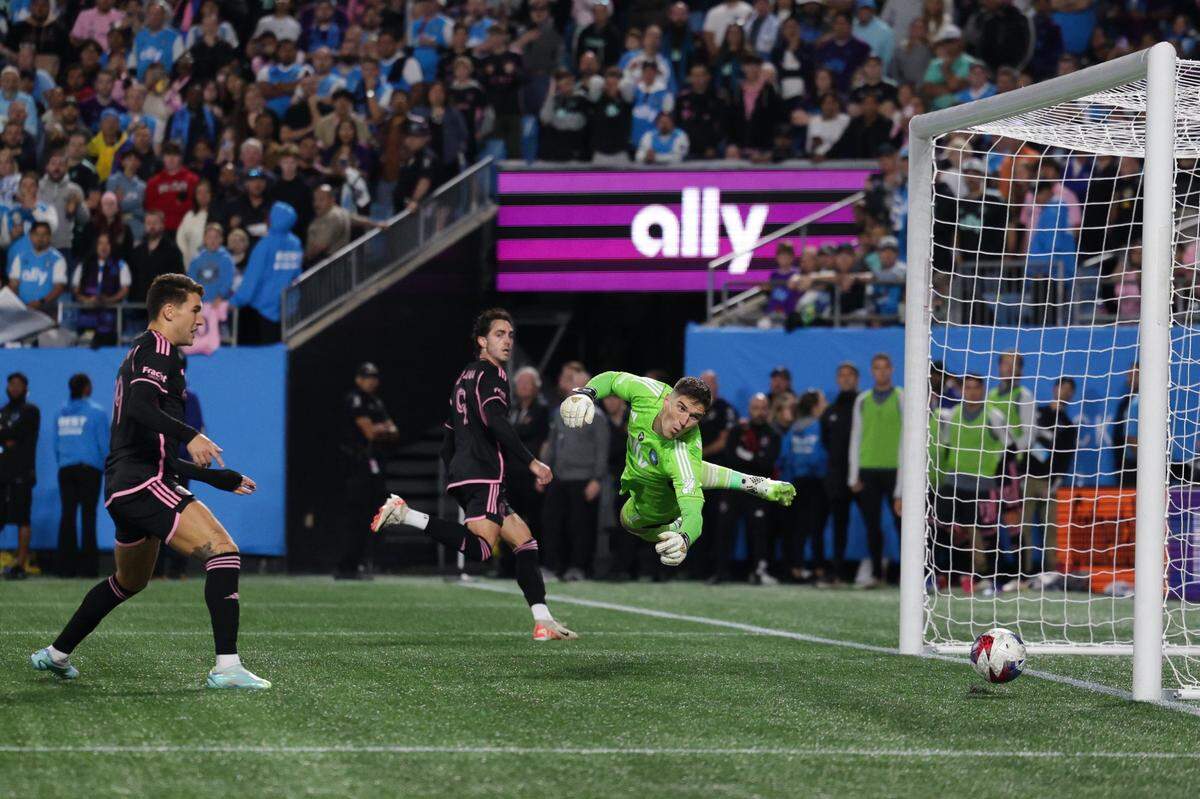 Charlotte FC goalkeeper Kristijan Kahlina, far right, dives for a corner kick that narrowly isses the net during the match against Inter Miami at Bank of America Stadium on Saturday, October 21, 2023 in Charlotte, NC. Charlotte FC held onto their lead to defeat Inter Miami, 1-0, clinching a spot in the playoffs.