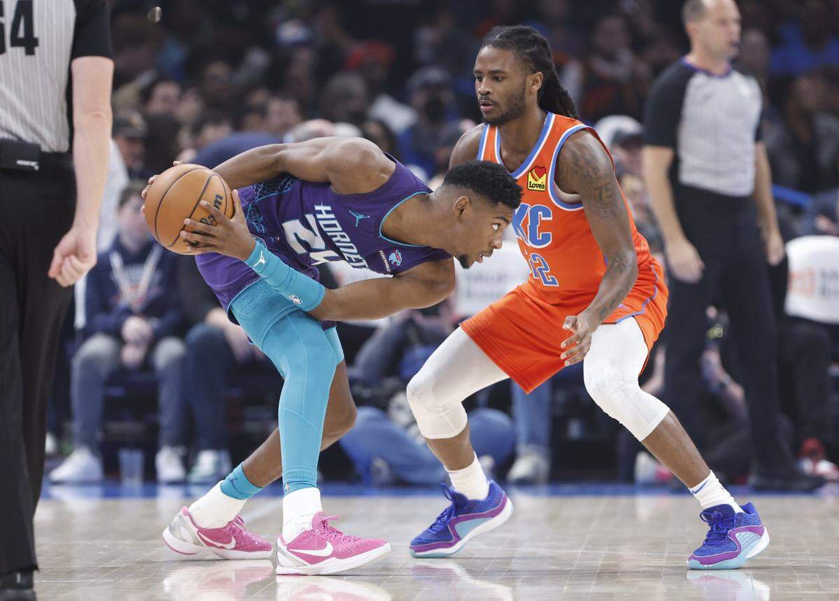 Charlotte Hornets forward Brandon Miller (24) moves the ball against Oklahoma City Thunder guard Cason Wallace (22) during the first quarter at Paycom Center.