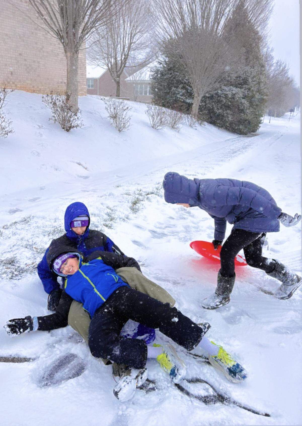 In this reader-submitted photo, members of the Kartha family enjoy the snow in Charlotte on Saturday, Jan. 31, 2026.