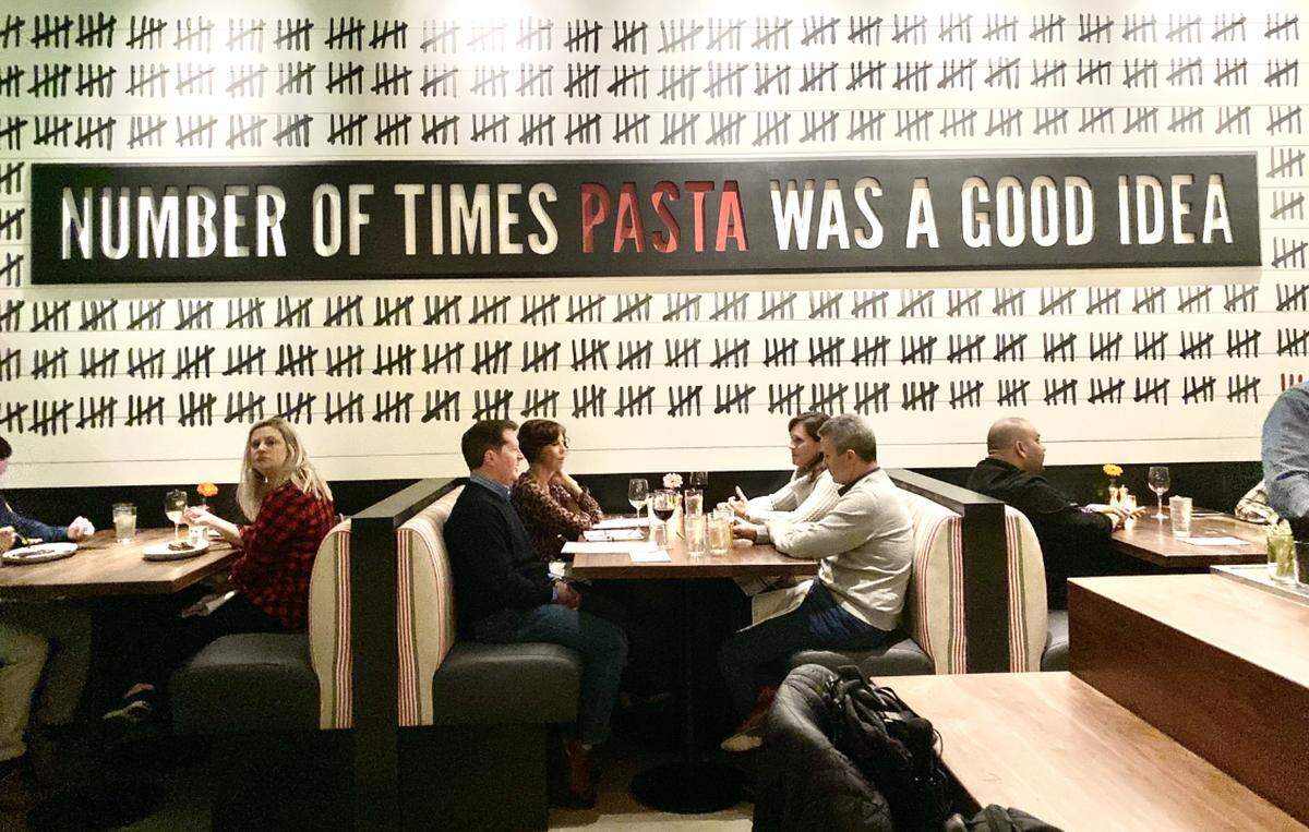 “Number of times pasta was a good idea” is written across the wall at North Italia.