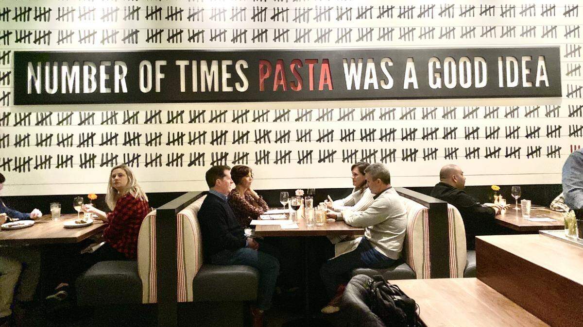 “Number of times pasta was a good idea” is written across the wall at North Italia.