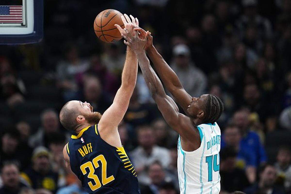 Jay Huff of the Indiana Pacers and Moussa Diabate of the Charlotte Hornets compete for a rebound in the first quarter at Gainbridge Fieldhouse on November 19, 2025 in Indianapolis, Indiana.