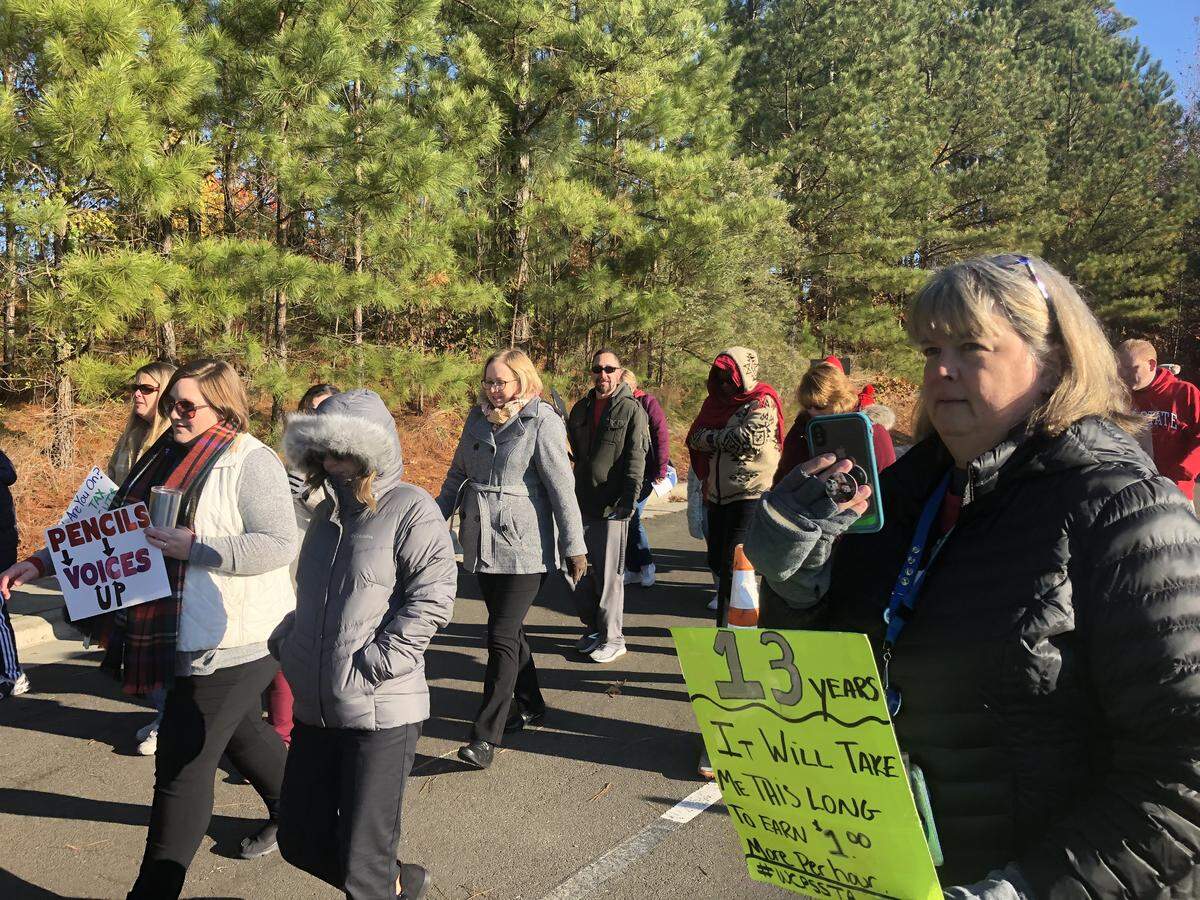 Around 75 school employees, parents and students marched into Harris Creek Elementary School in Raleigh, N.C., on Nov. 13, 2019 demanding that state lawmakers give all school workers a 5% raise and expand Medicaid funding.