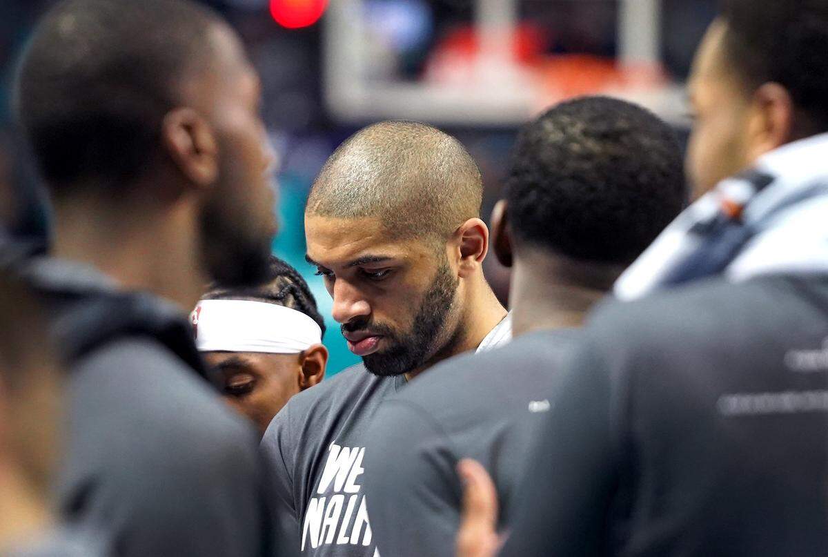 Charlotte Hornets guard Nicolas Batum, center, stands in a team huddle during a timeout listening to head coach James Borrego during second half action against the Orlando Magic at Spectrum Center in Charlotte, NC on Monday, January 20, 2020. The Magic defeated the Hornets 106-83.