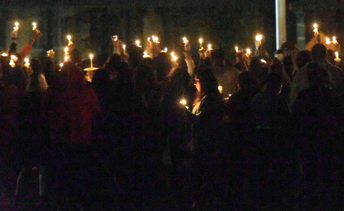 Students hold candles during a vigil at Butler High School on Monday night. Earlier in the day, 16-year-old Bobby McKeithen was fatally shot in the school.