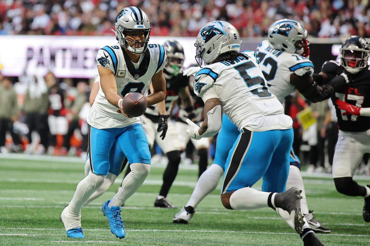 Carolina’s Bryce Young hands the ball off to Rico Dowdle during the fourth quarter of Sunday’s game against the Atlanta Falcons at Mercedes-Benz Stadium in Atlanta. 