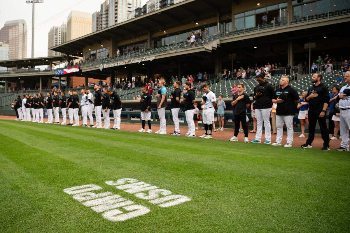 A moment of silence for law officers who were killed on Monday, April 29, 2024 in east Charlotte took place before the 6:05 p.m. game between the Charlotte Knights and Memphis Redbirds at Truist Field.