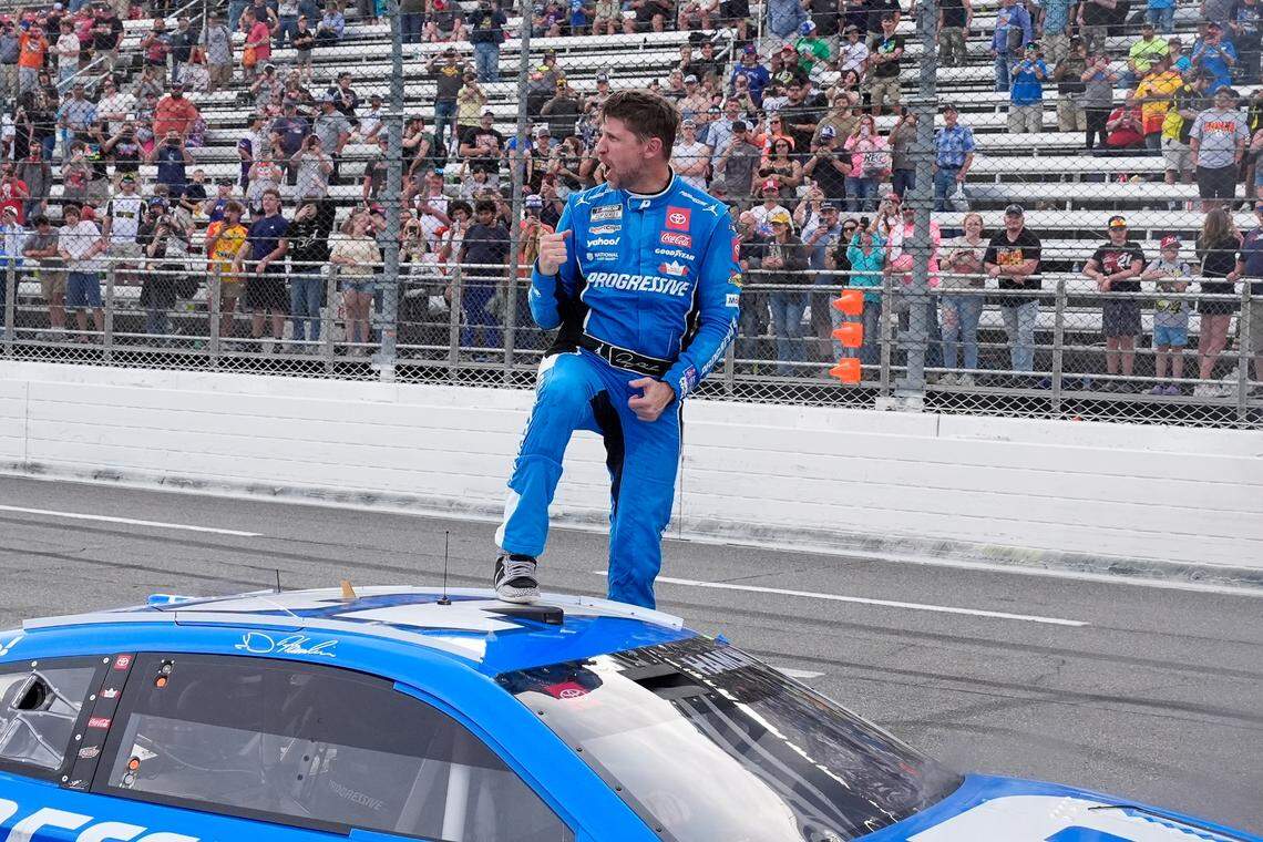 Mar 30, 2025; Martinsville, Virginia, USA; NASCAR Cup Series driver Denny Hamlin (11) reacts after his win at the Cook Out 400 at Martinsville Speedway.