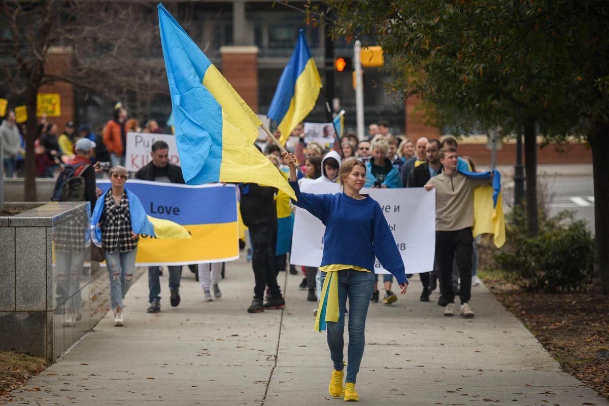 Anastasiia Teremtieva, of Charlotte, N.C. waves a Ukrainian flag while marching with about 200 other people during a gathering to show support for Ukraine at Romare Bearden Park in Charlotte, Thursday, Feb. 24, 2022. Teremtieva was born in Kharkiv, Ukraine and moved to the United States about five years ago.
