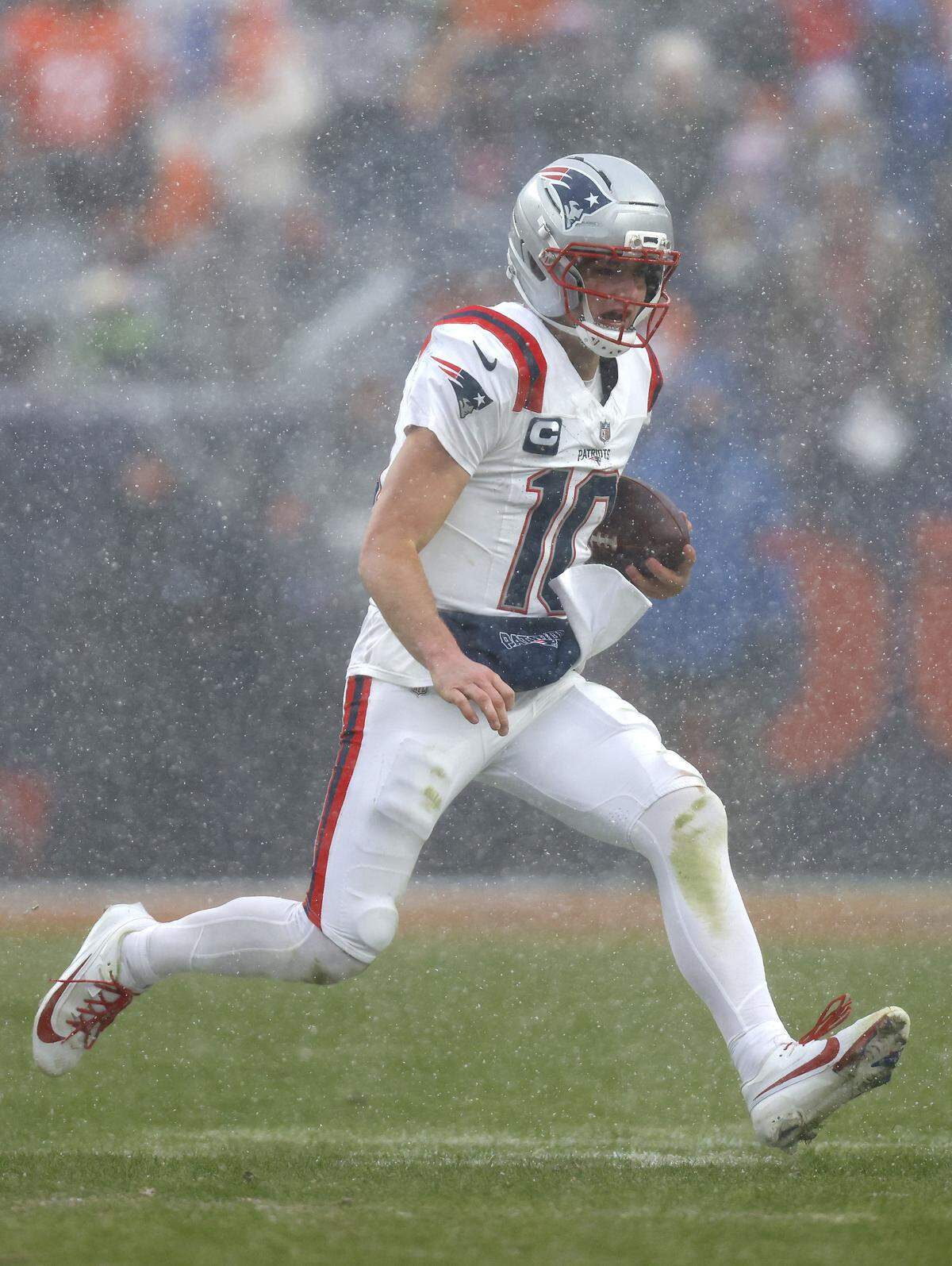 New England Patriots quarterback Drake Maye rushes for yards during the third quarter in the AFC Championship Playoff game against Talanoa Hufanga of the Denver Broncos at Empower Field At Mile High on Sunday. The Patriots won, 10-7, with Maye rushing for 65 yards.