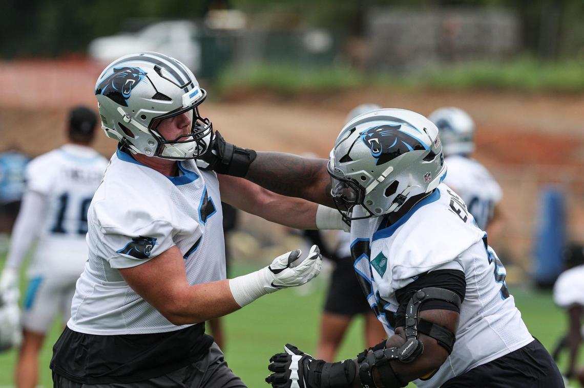 Panthers offensive linemen Jarrett Kingston, left, and Damien Lewis run through a drill during the first day of minicamp on June 10.
