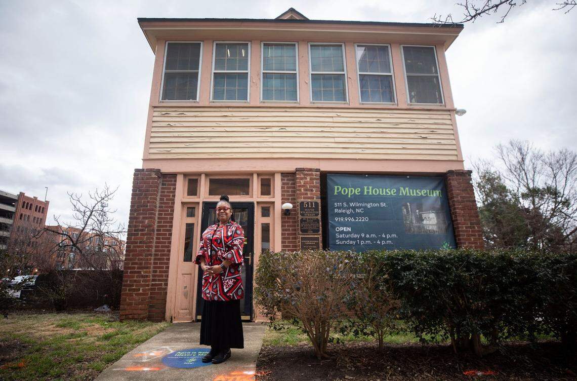 Bettina Pope, the great-grandniece of Dr. Manassa T. Pope, poses for a portrait outside of the Pope House Museum in downtown Raleigh in 2022.