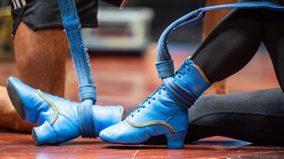 Hitomi Nishikii Kinokuniya straps her shoes onto the swinging rope during the Cirque Du Soleil’s CORTEO rehearsal on August 1, 2024, at the Bojangles Coliseum.