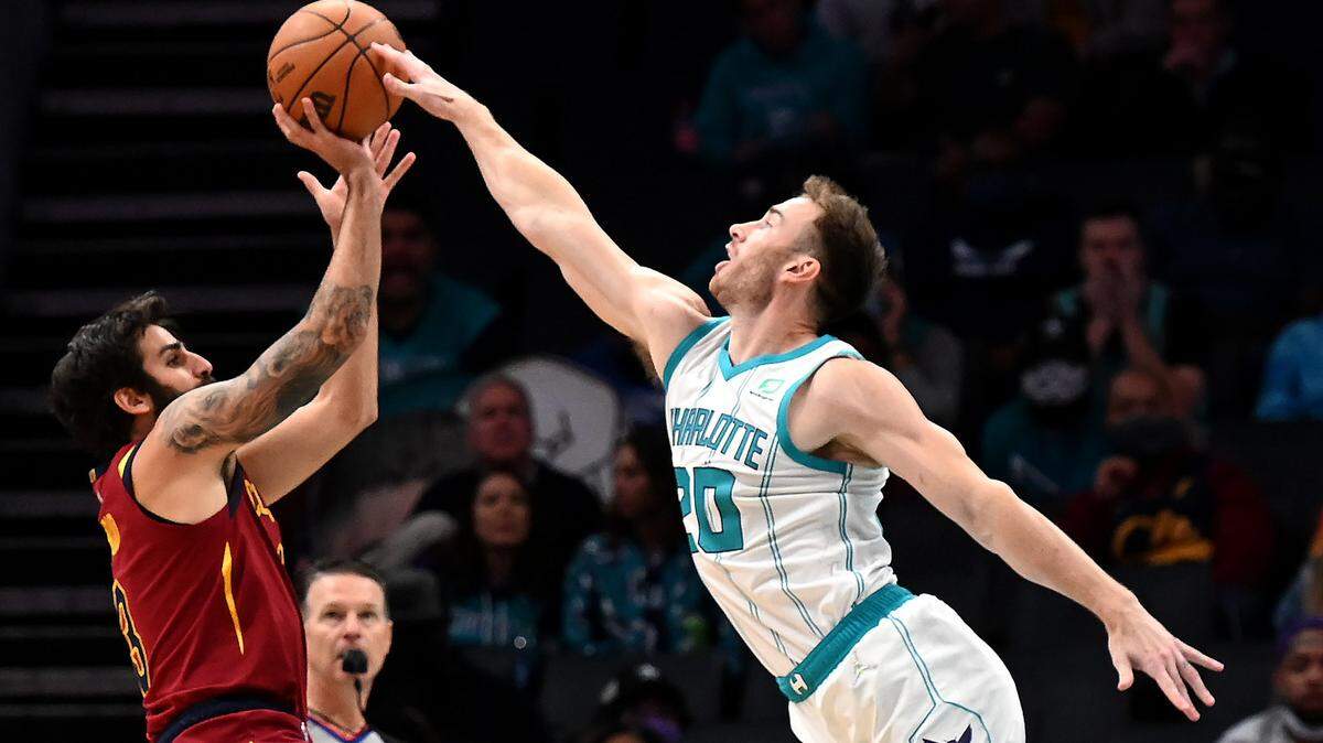 Charlotte Hornets forward Gordon Hayward, right, blocks a shot attempt by Cleveland Cavaliers guard Ricky Rubio, left, during first half action at Spectrum Center in Charlotte, NC on Monday, November 1, 2021.