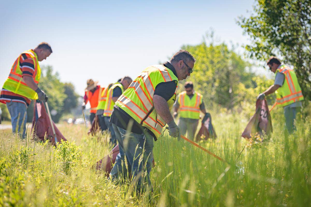 North Carolina Department of Transportation volunteers clean up trash on the side of roadways in April 2024.