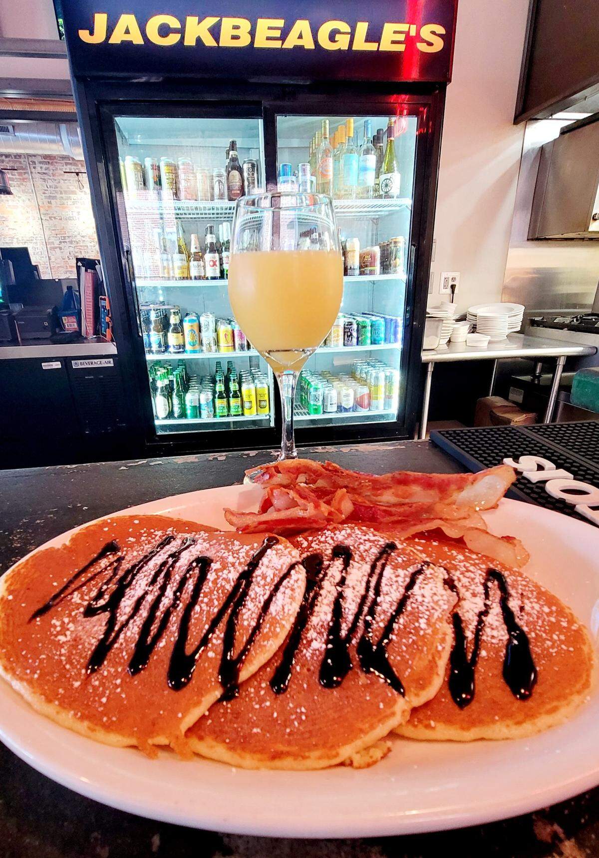 JackBeagle’s pancakes with powdered sugar and chocolate syrup.