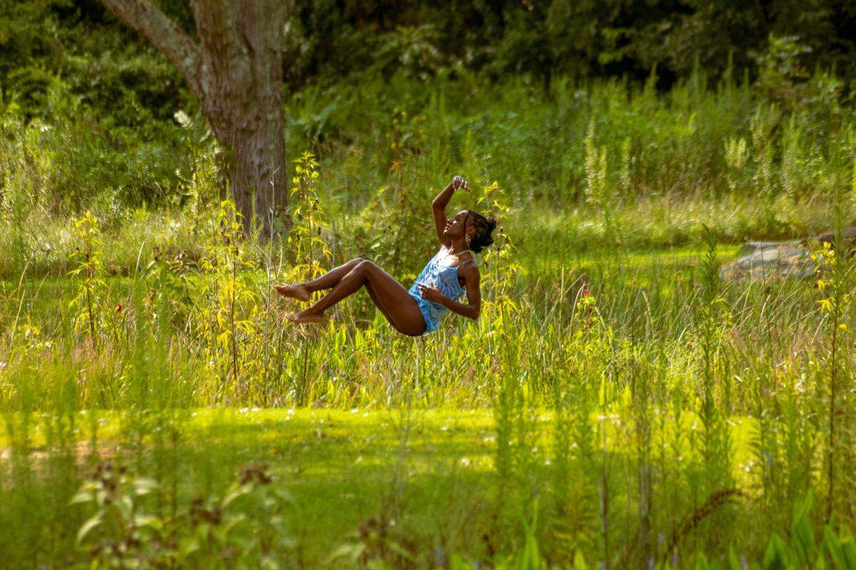 “Float” by Patrick Sainte and Dasia Hood. That’s Hood in the photo, part of the upcoming “Dark & Divine” exhibit at the McColl Center.