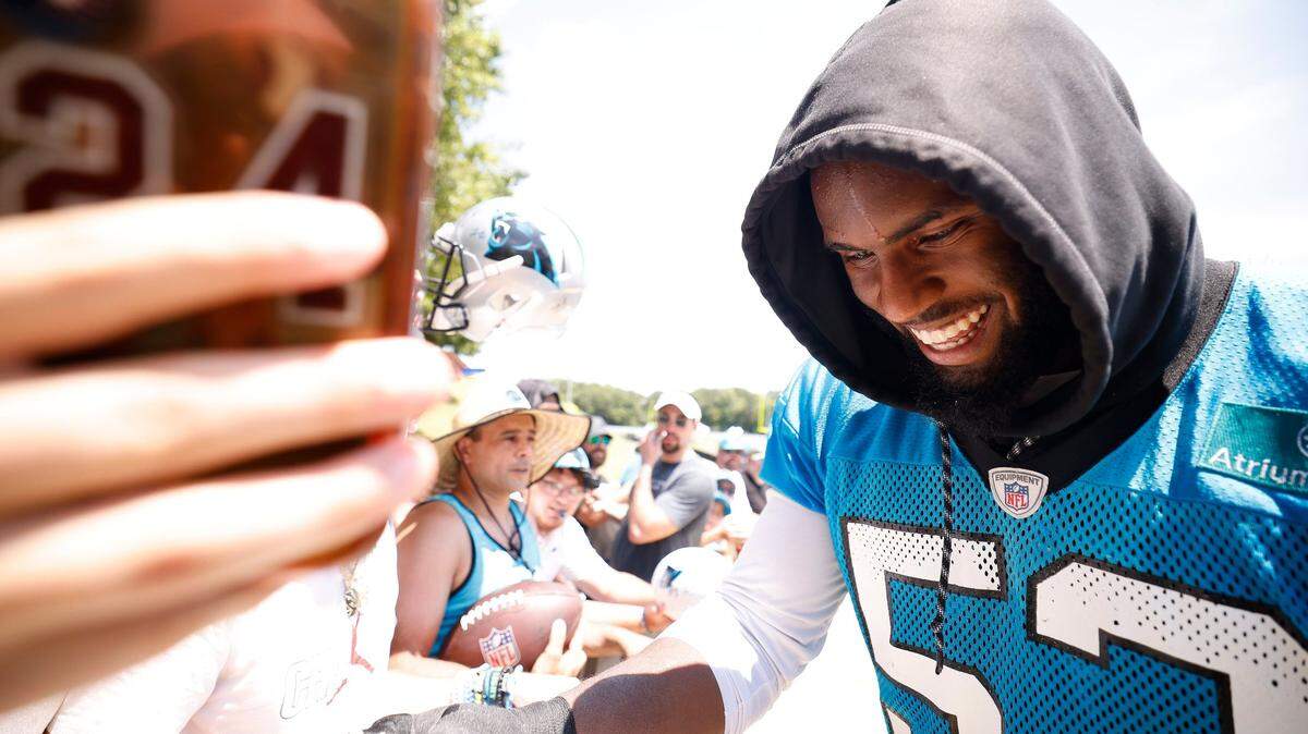 Carolina Panthers defensive end Brian Burns (53) signs autographs for fans after a practice in Spartanburg, S.C., on Thursday.