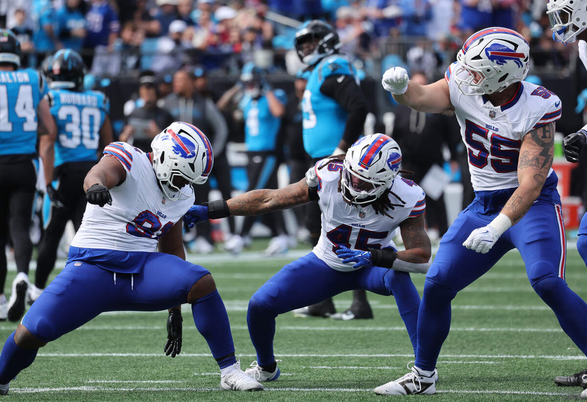 Buffalo Bills, from left, Ed Oliver, Shaq Thompson and Michael Hoecht dance in celebration after Carolina Panthers quarterback Andy Dalton is sacked during Sunday’s game at Bank of America Stadium.