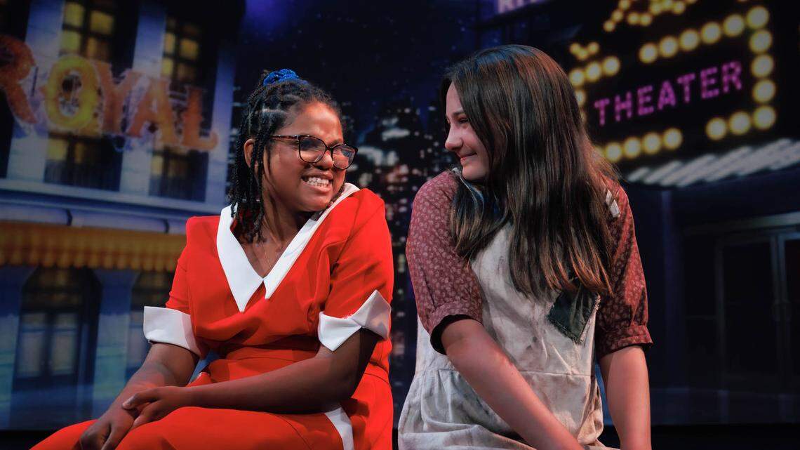 Kate Jewett, left, is Annie, and Lainey Hembree is her mentor in “Annie, Jr.” The show is a collaboration between Theatre Charlotte and The Penguin Project, which works to empower students with special needs to explore creativity through theater. Cast members are paired with mentors in the show.