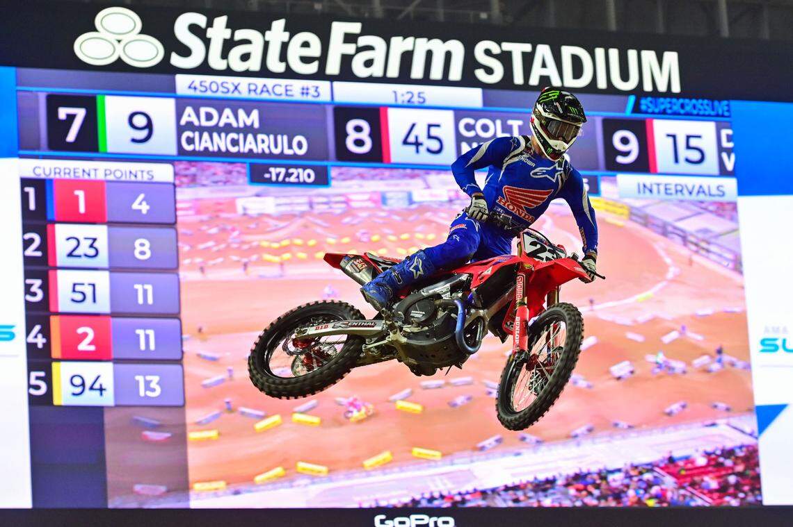 Apr 8, 2023; Glendale, Arizona, USA; 450SX rider Chase Sexton (23) jumps in race 3 during Round 12 of the Monster Energy AMA Supercross Championship at State Farm Stadium.