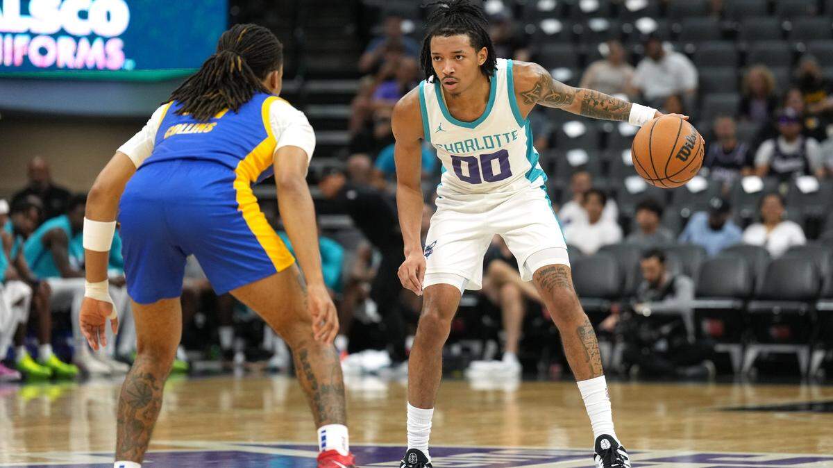 Charlotte Hornets guard Nick Smith Jr. (00) dribbles against Golden State Warriors guard Yuri Collins (41) during the third quarter at Golden 1 Center.