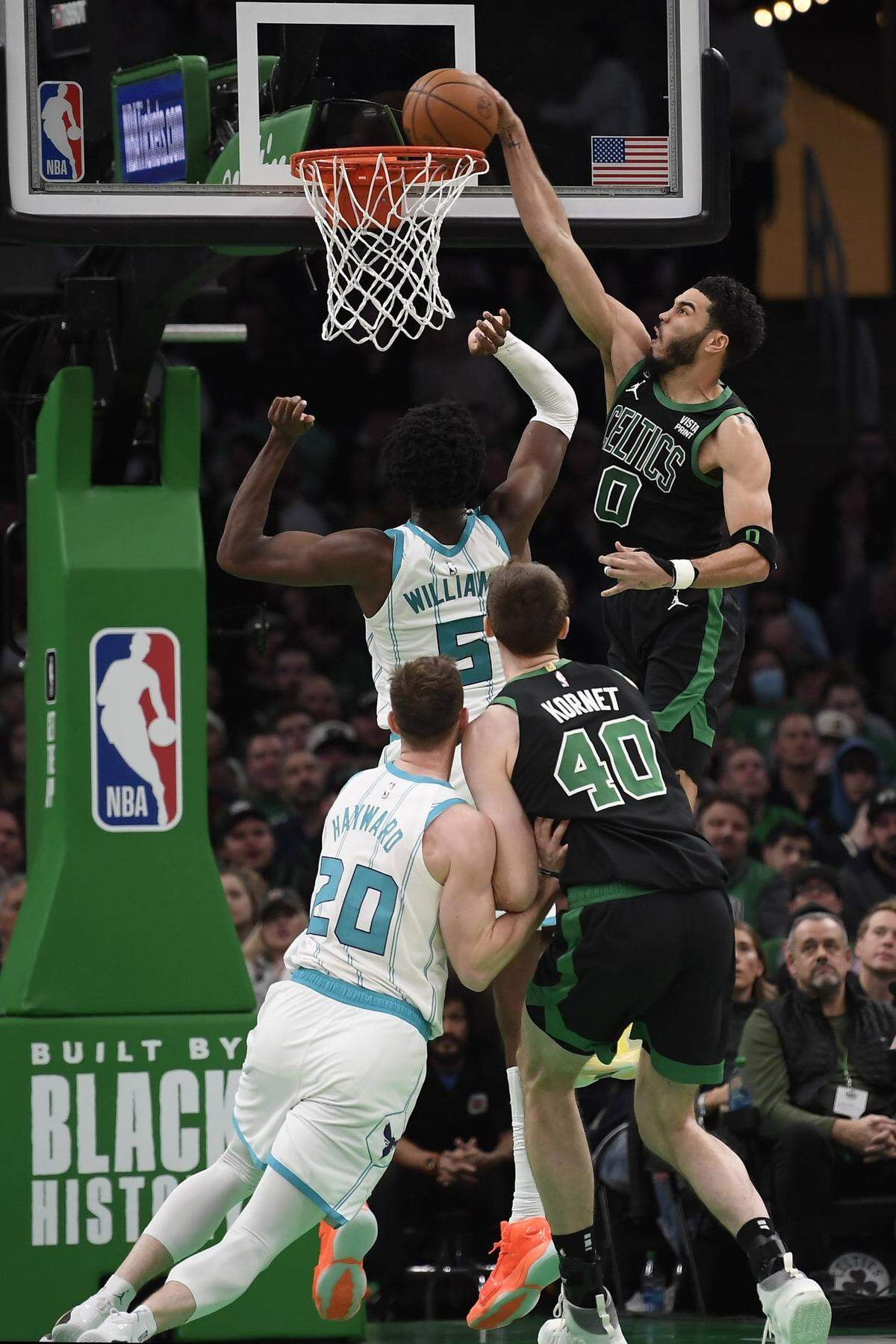 Feb 10, 2023; Boston, Massachusetts, USA; Boston Celtics forward Jayson Tatum (0) dunks the ball over Charlotte Hornets center Mark Williams (5) during the second half at TD Garden. Mandatory Credit: Bob DeChiara-USA TODAY Sports