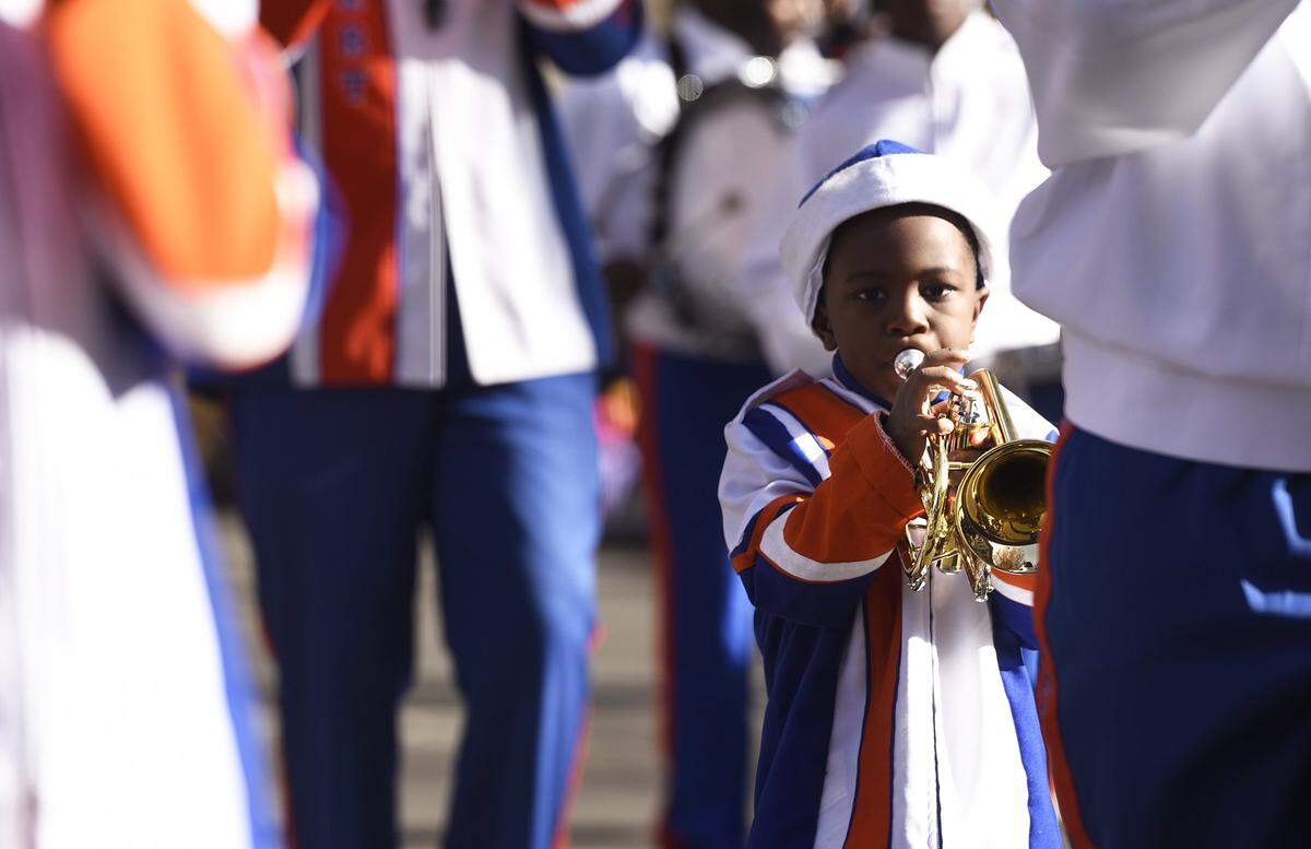 Five-year-old Desmond Kennedy blew his trumpet alongside the rest of the United House of Prayer Marching Band as they marched down Tryon Street in 2019 in the Novant Health Thanksgiving Parade.  The 2021 version will be a night parade at 6 p.m. Nov. 24.