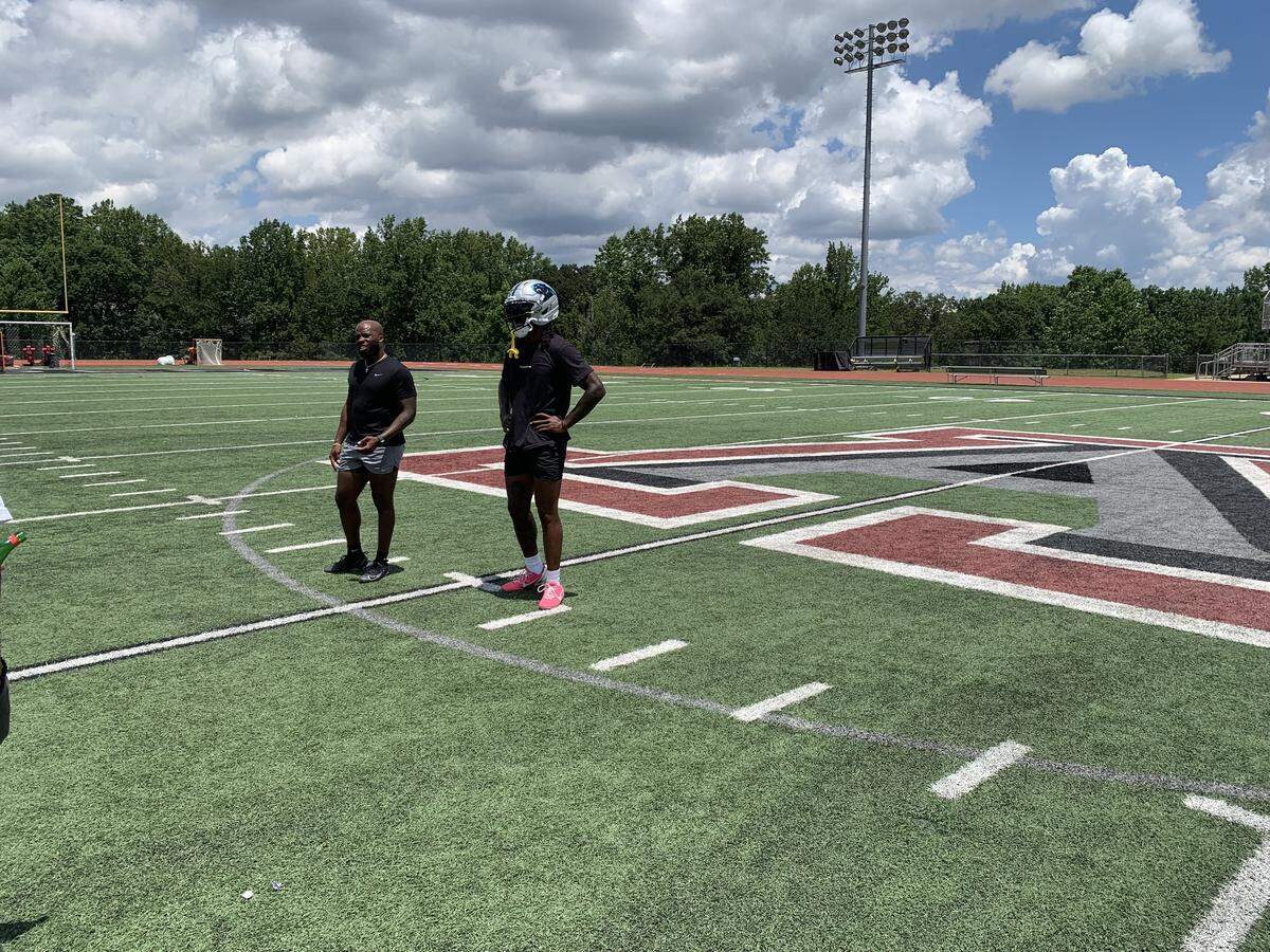 Carolina Panthers cornerback Jaycee Horn (right) begins a workout with longtime trainer Oliver Davis (left) on July 18, 2025, at Alpharetta High School in Alpharetta, Ga.