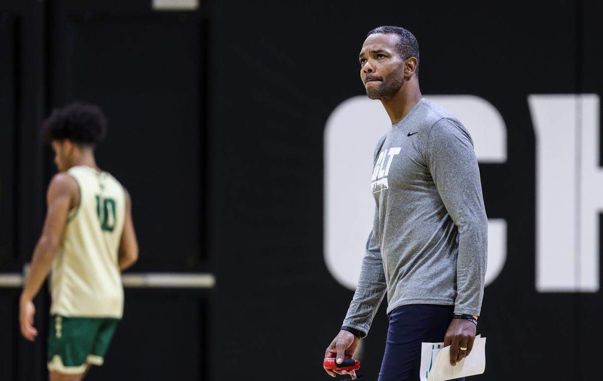 Charlotte 49ers coach Ron Sanchez walks across the court during practice at the Halton Arena at in Charlotte, N.C., on Wednesday, November 2, 2022.