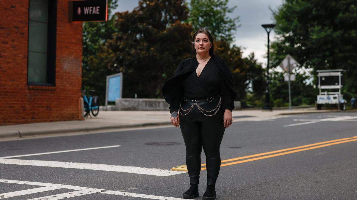 No Kings protestor Lindsey Key stands in the place on 7th Street where she says a CMPD officer hit her with a bike in uptown. Key called 911 to report the incident and has filed a report.