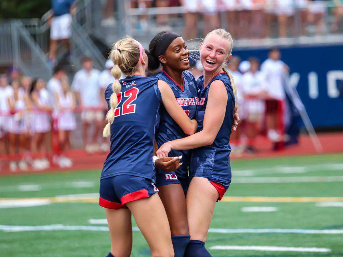 Providence day embrace in a victory hug after a hard fought game against Charlotte Latin at the NCISAA girls soccer finals at Providence Day