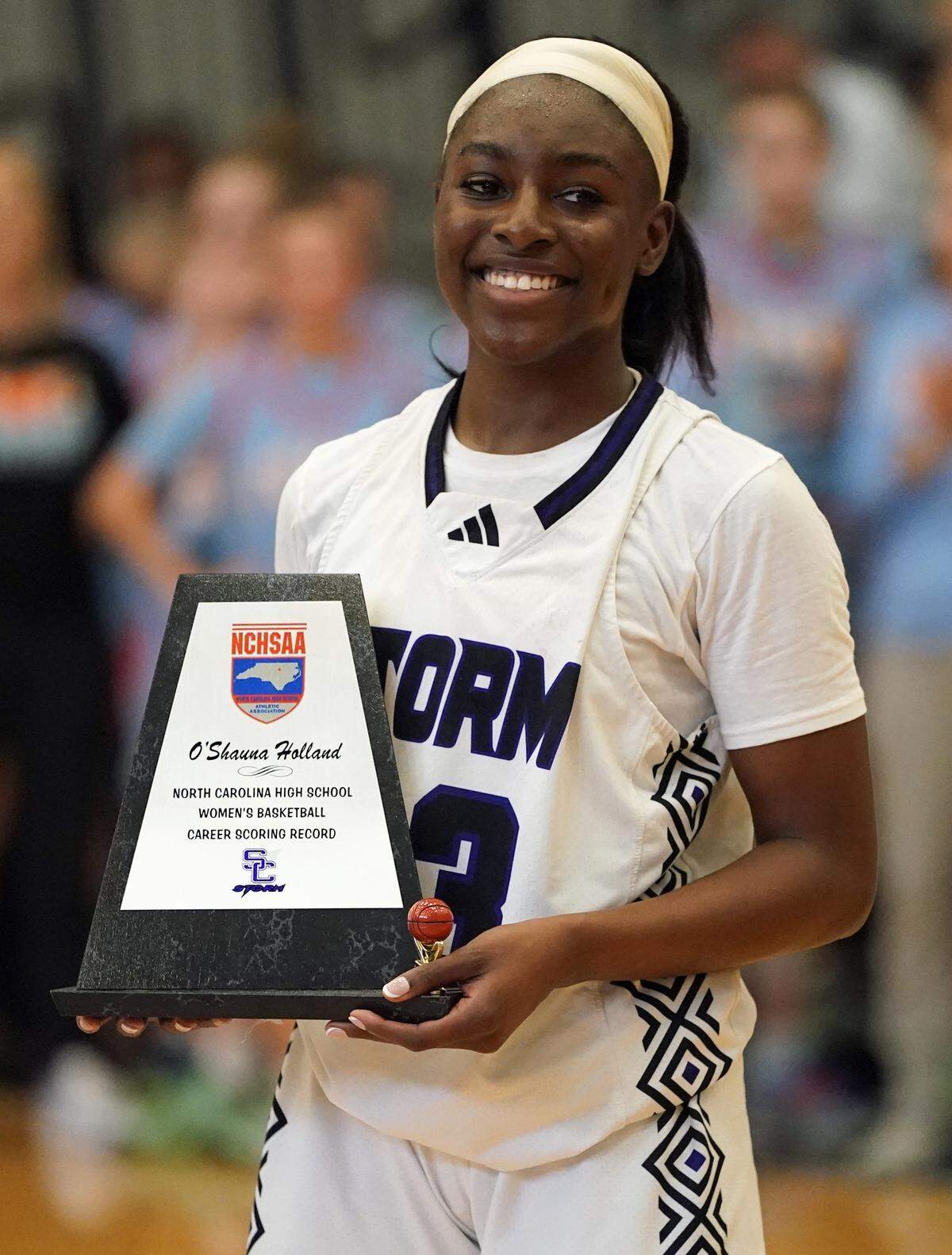 Stuart W. Cramer guard O'Shauna Holland with the plaque she received from the N.C. High School Athletic Association after setting a new state career scoring record during the Storm's third-round NCHSAA 4A Western Regional playoff game against Newton's Fred T. Foard High on Feb. 28, 2026, in Belmont, North Carolina. (Bill Kiser/Special to the Charlotte Observer)