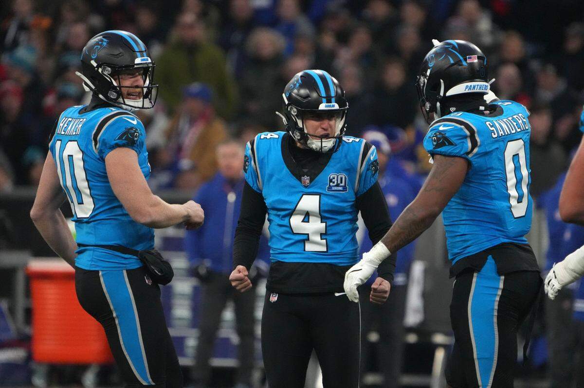 Nov 10, 2024; Munich, Germany; Carolina Panthers place kicker Eddy Pineiro (4) celebrates with punter Johnny Hekker (10) and tight end Ja'Tavion Sanders (0) after kicking a 53-yard field goal against the New York Giants in the first half during the 2024 NFL Munich Game at Allianz Arena. Mandatory Credit: Kirby Lee-Imagn Images