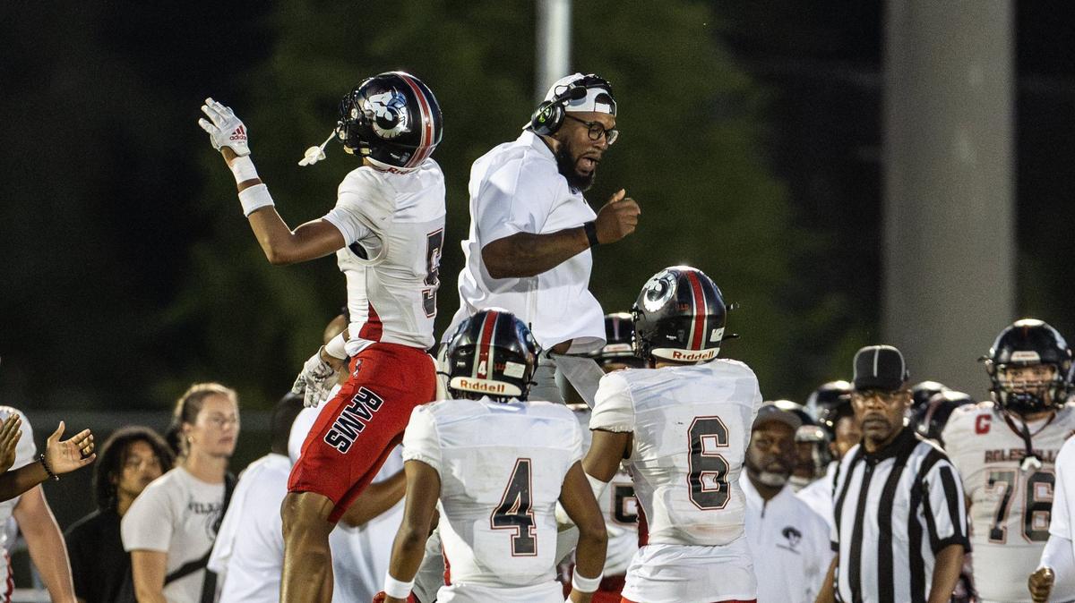 Rolesville Rams celebrate a turnover against the Butler Bulldogs at Butler High School in Matthews, N.C., on Friday, August 23, 2024.