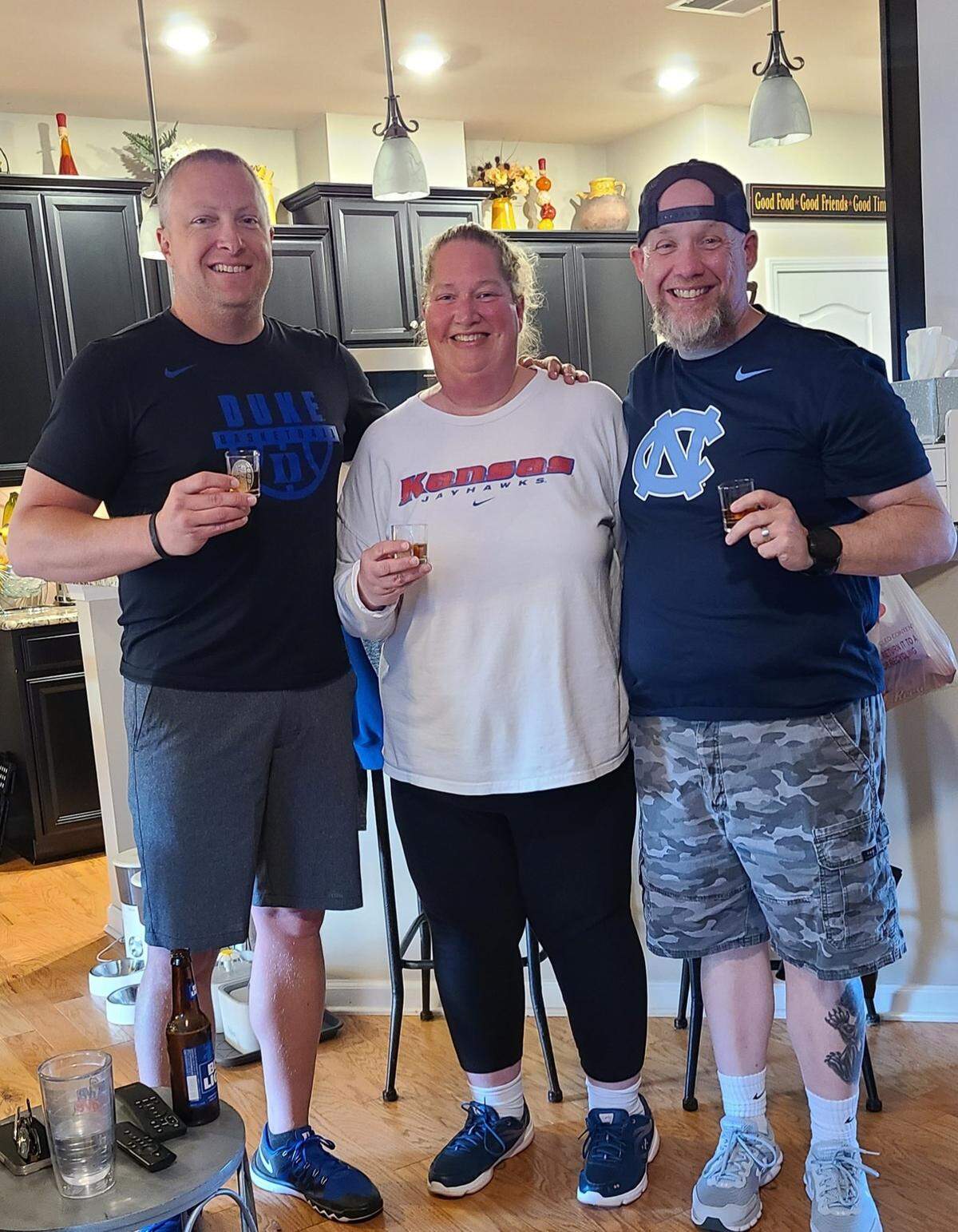 Duke fan Ryan Walton, Kansas fan LeAnn Harriss and Carolina fan Rob Harriss.