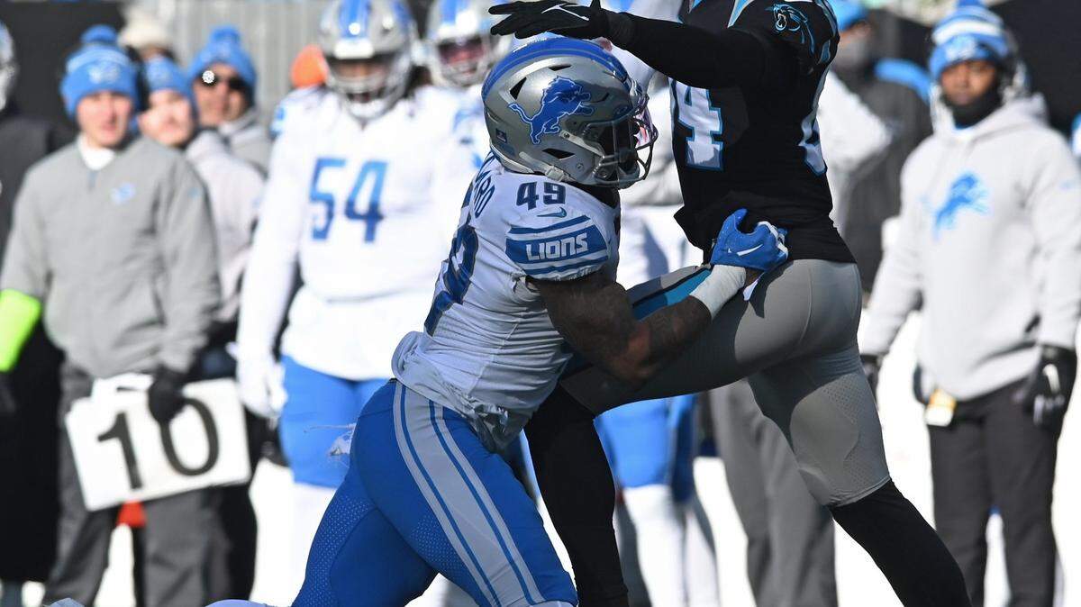 Carolina Panthers tight end Stephen Sullivan, right, battles in an attempt to make a pass reception against Detroit Lions linebacker Chris Board, left, during second quarter action at Bank of America Stadium on Saturday, December 24, 2022 in Charlotte, NC.