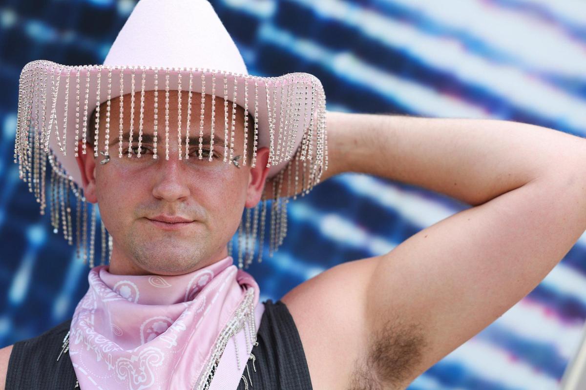 Justin Pettit, from Raleigh, poses after purchasing a shirt before seeing Beyonce tonight at Bank of America Stadium on Wednesday, August 9, 2023 in Charlotte, NC.