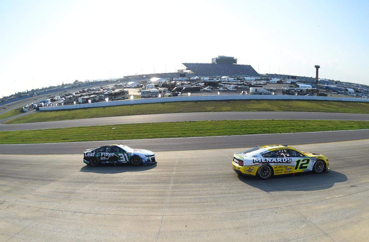 Jun 25, 2023; Nashville, Tennessee, USA; NASCAR Cup Series driver Ryan Blaney (12) and NASCAR Cup Series driver Justin Haley (31) race out of turn two during the Ally 400 at Nashville Superspeedway. Mandatory Credit: Christopher Hanewinckel-USA TODAY Sports