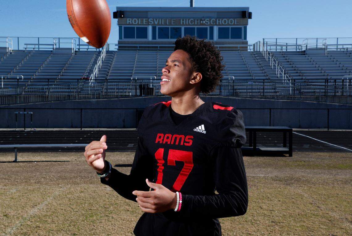Byrum Brown, quarterback at Rolesville High School in Wake Forest, N.C., poses on the field Tuesday, November 30, 2021.