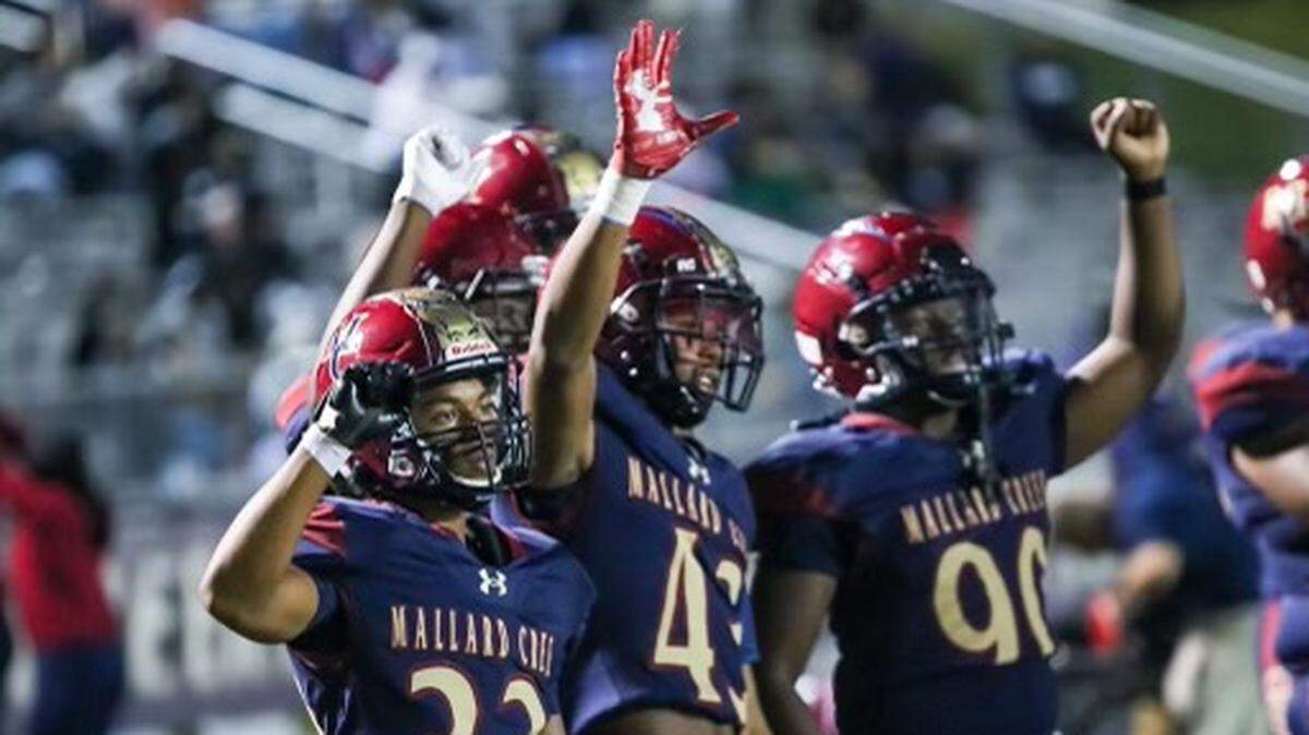 Mallard Creek Players cheer as their team pulls ahead with a 20-0 lead at half time