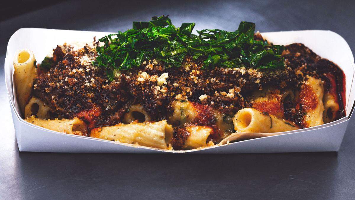 Another!? Food Truck serves up its Dirty Mac with braised beef, collard greens and Average Sauce, topped with a cornbread crumble. 
