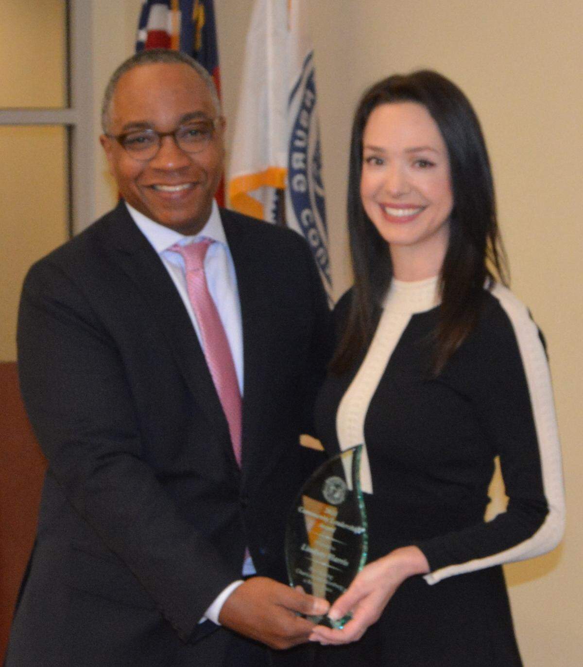 Mecklenburg District Attorney Spencer Merriweather awards Lindsay Harris with the Community Leadership Award.