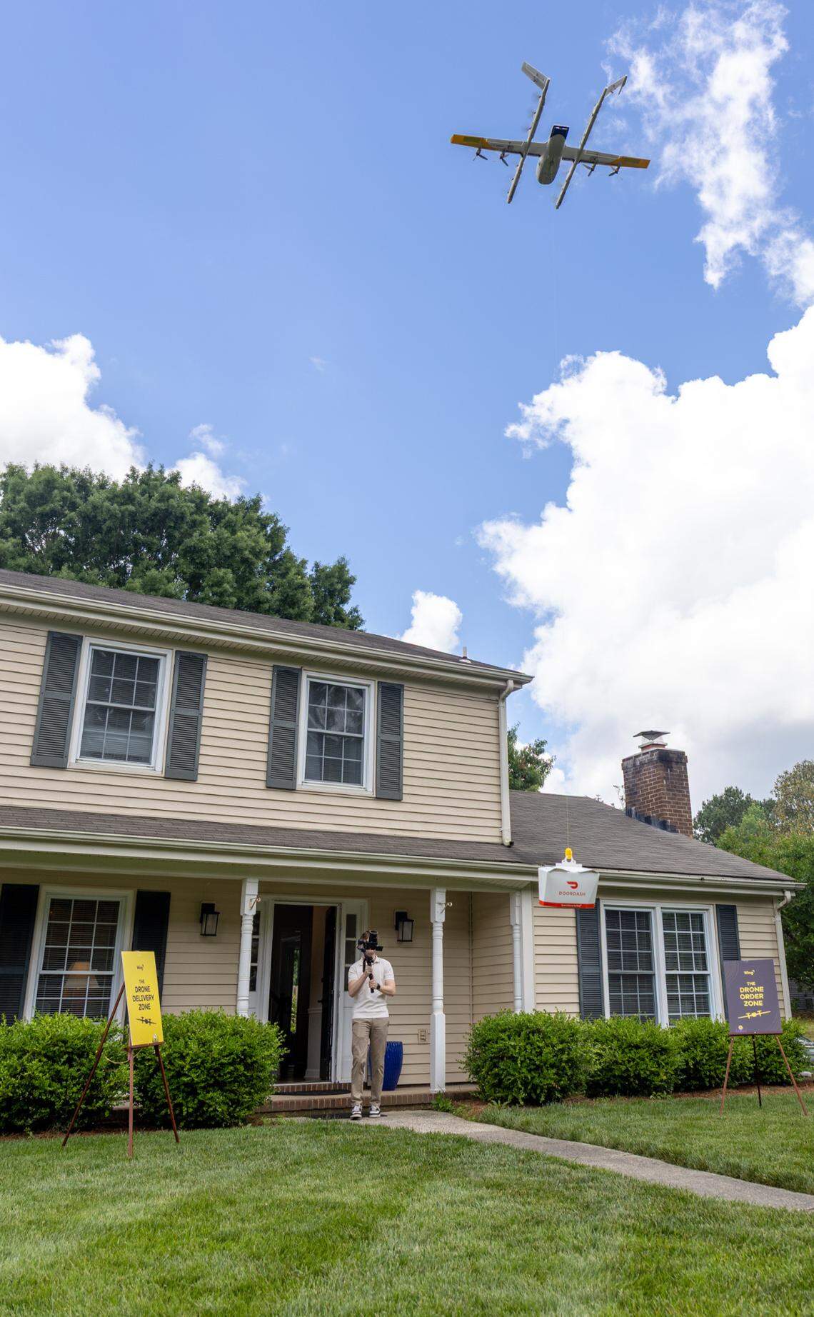A Wing delivery drone drops off a DoorDash delivery container at a home in south Charlotte.