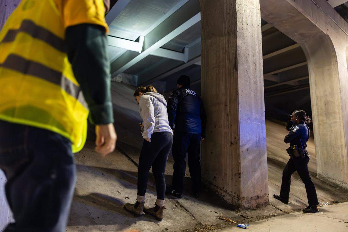 Volunteers and police officers check an underpass for unhoused people during the 2026 Point-in-Time Count in Charlotte, N.C., on Thursday, January 22, 2026.