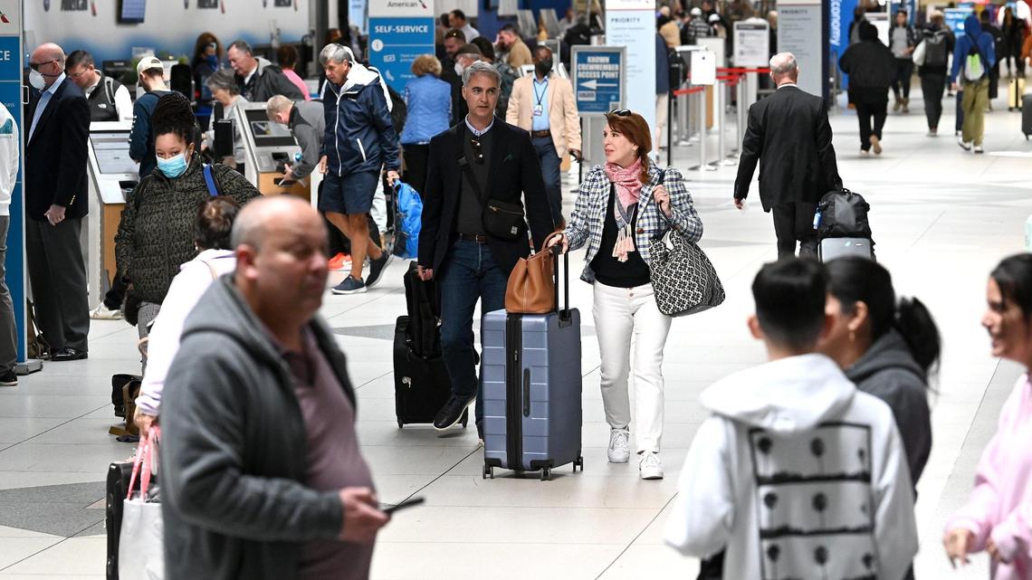 Travelers wearing masks and not walk through Charlotte Douglas International Airport on Tuesday, April 19, 2022.