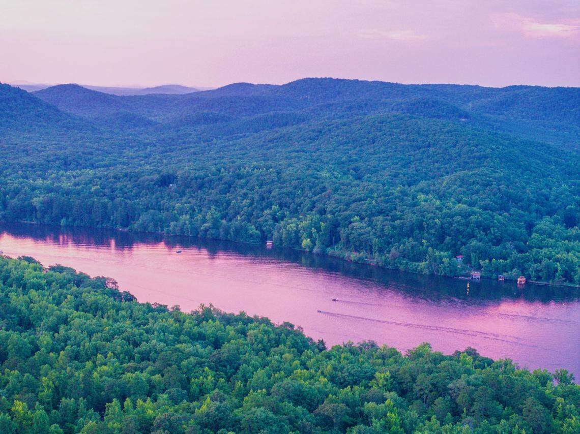 A sunset drone image from Morrow Mountain State Park captures an expansive view of the water. Morrow Mountain State Park borders part of Lake Tillery.