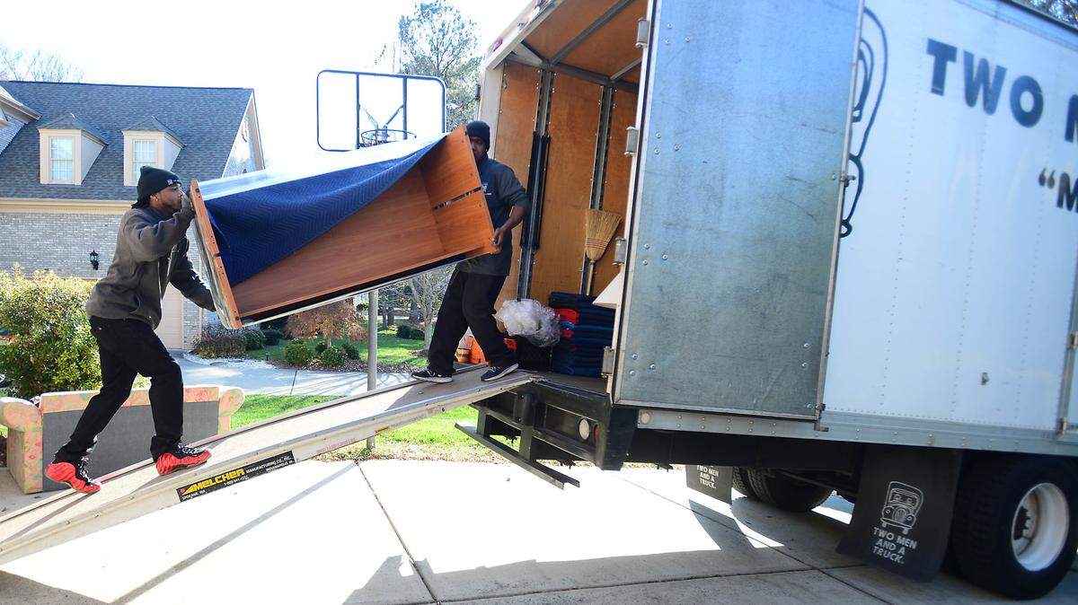 Workers load furniture into the moving truck at a south Charlotte home Friday, Nov. 28, 2014.